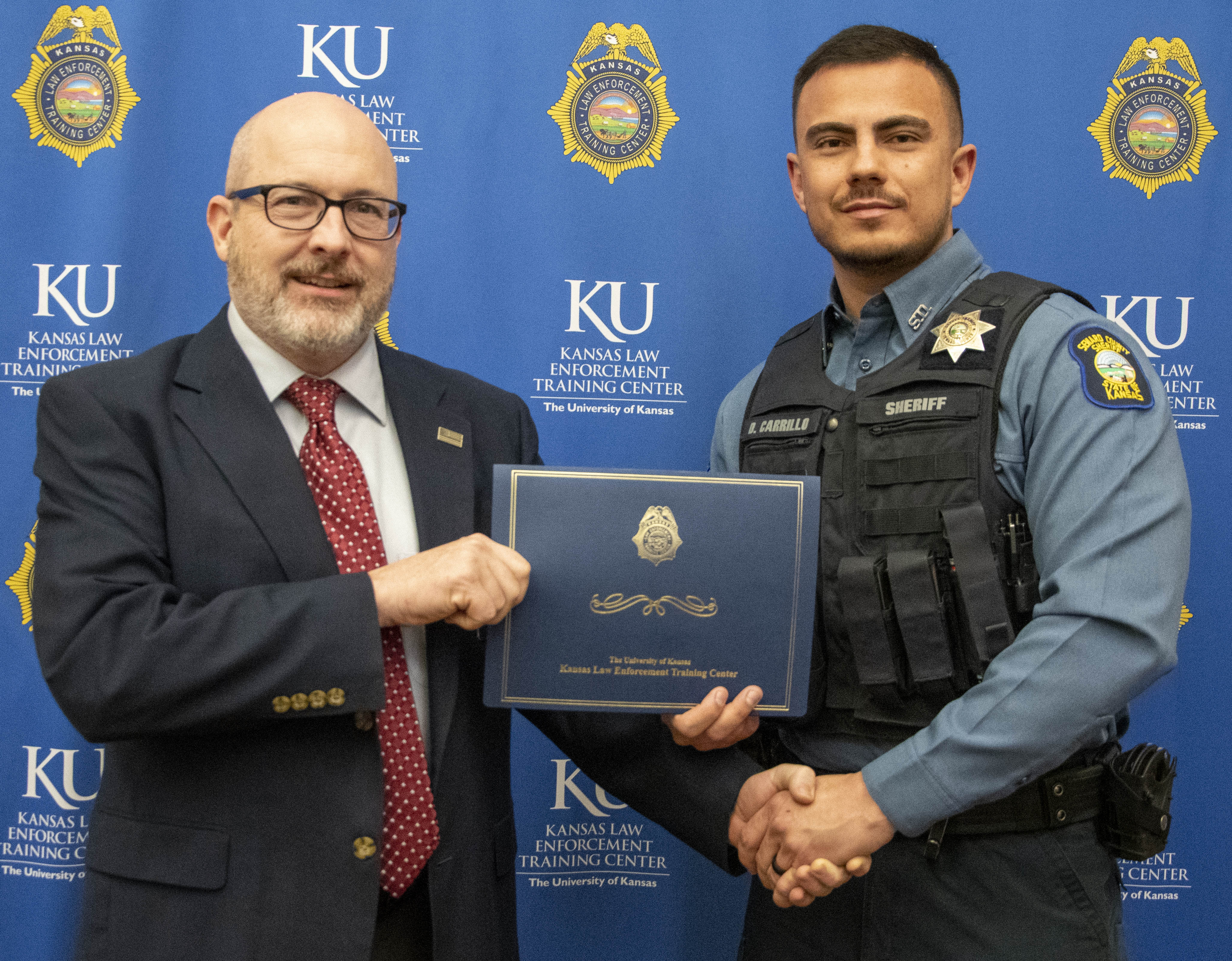 "KLETC Executive Director Darin Beck stands with the class president of the 289th, Deputy David Carrillo"