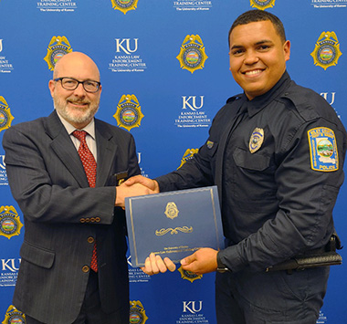 "KLETC Executive Director Darin Beck poses with the 295th Class President Officer Andrew Lee of the Riley County Police Department "