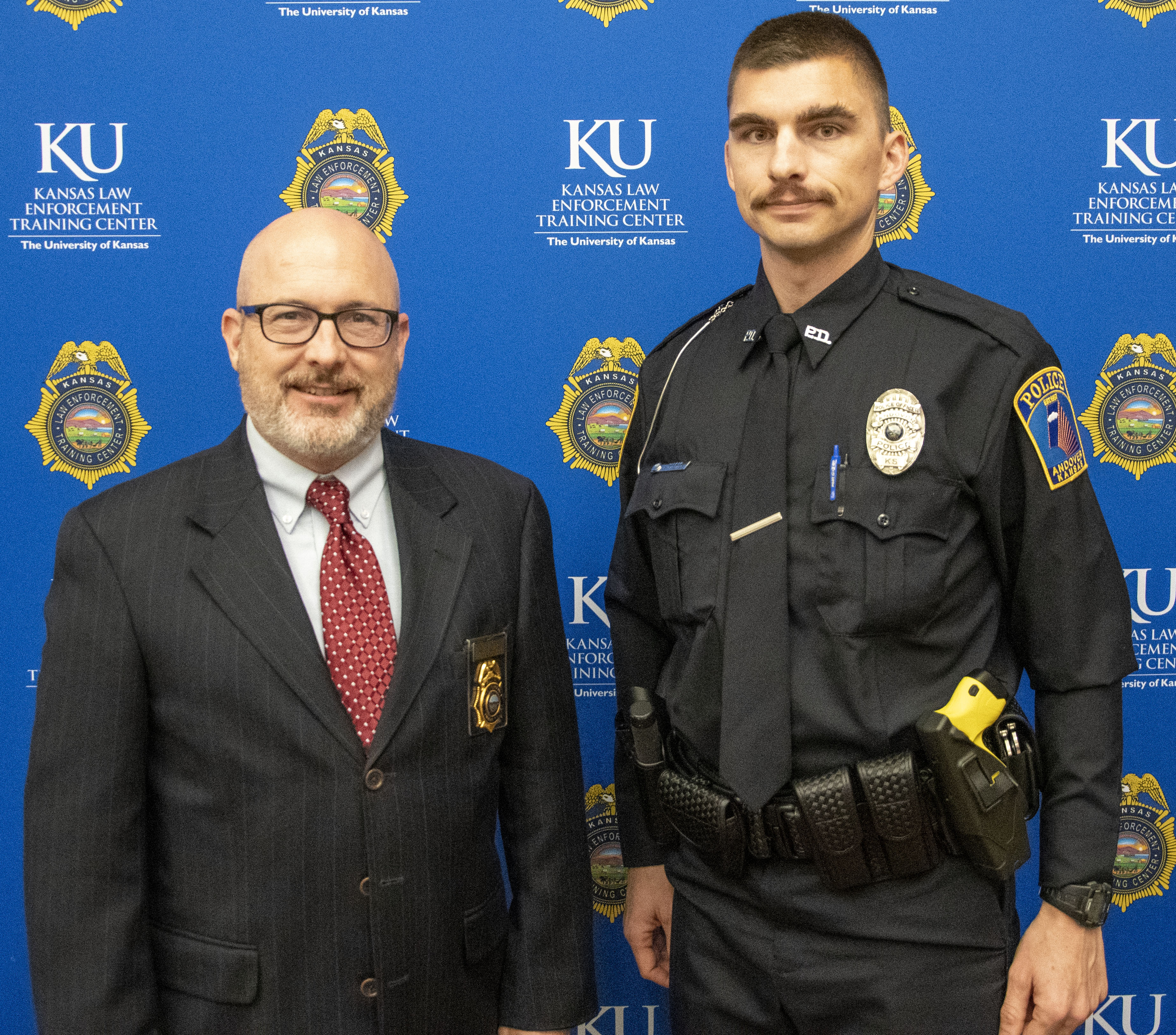 "KLETC Executive Director Darin Beck stand with class president Officer Robert Garland"