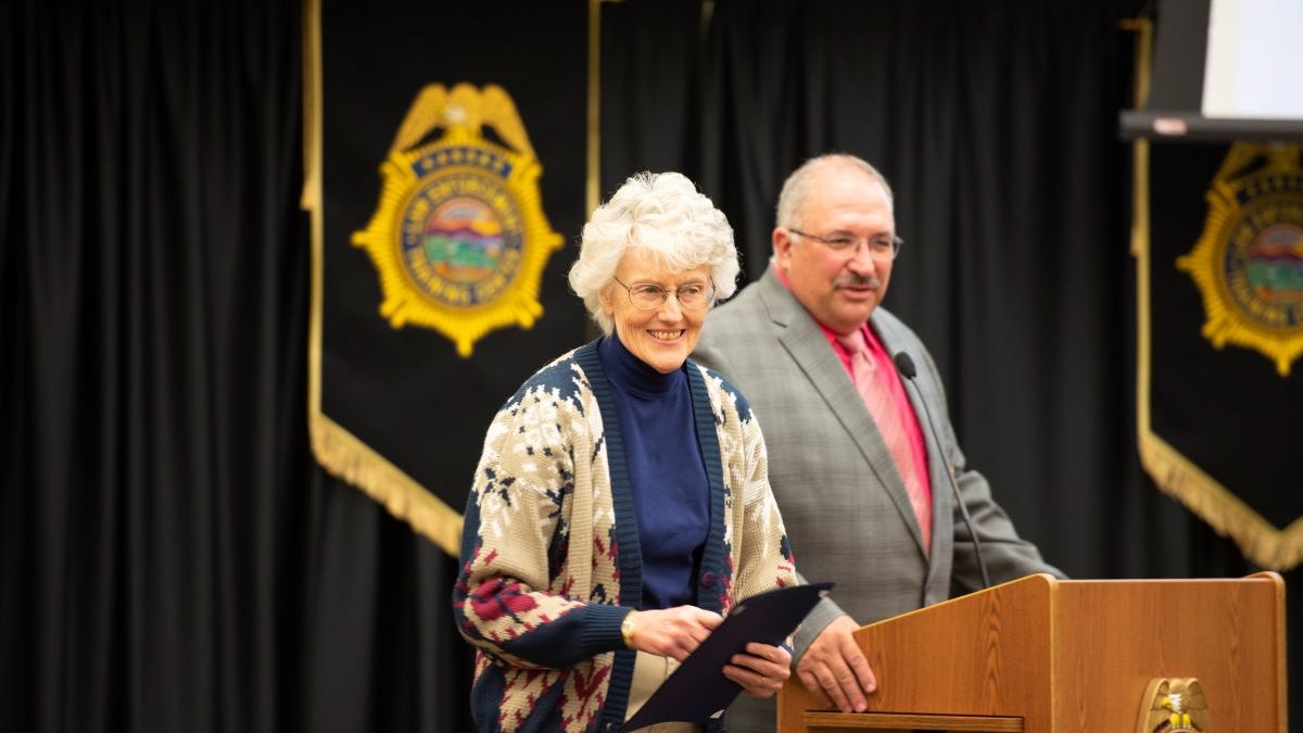KLETC Executive Director Darin Beck delivers remarks at Beckie Miller's retirement celebration before presenting her a letter from KU Provost Carl Lejuez and Chancellor Douglas A. Girod granting her Emeritus status.