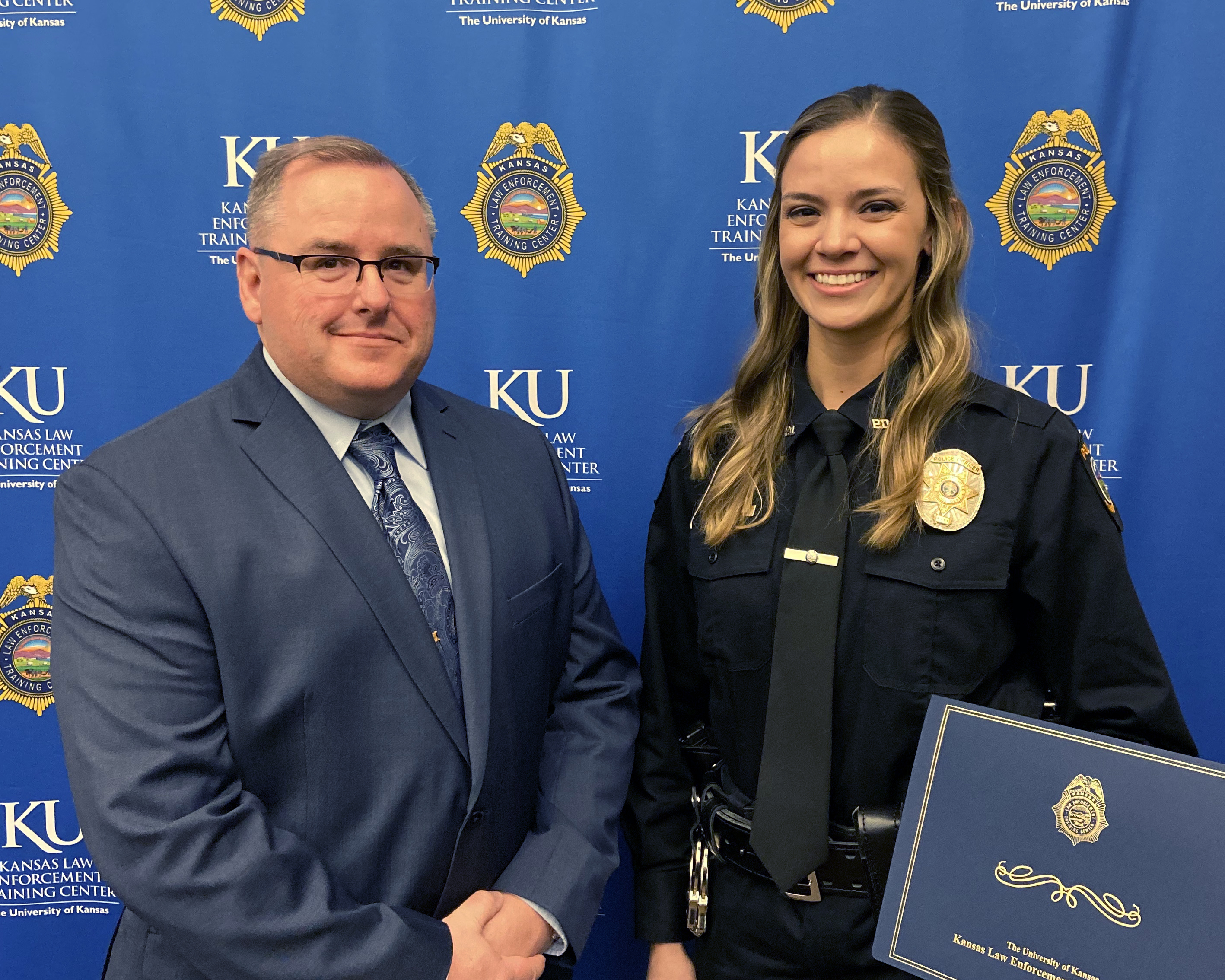 Sheriff Andrew Dedeke stands with the 262 class president Jennifer Richner of the Edwardsville Police Department