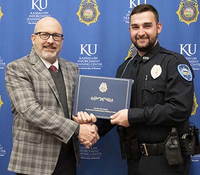 KLETC Executive Director Darin Beck stands with the 288th class president Officer Curtis Morse