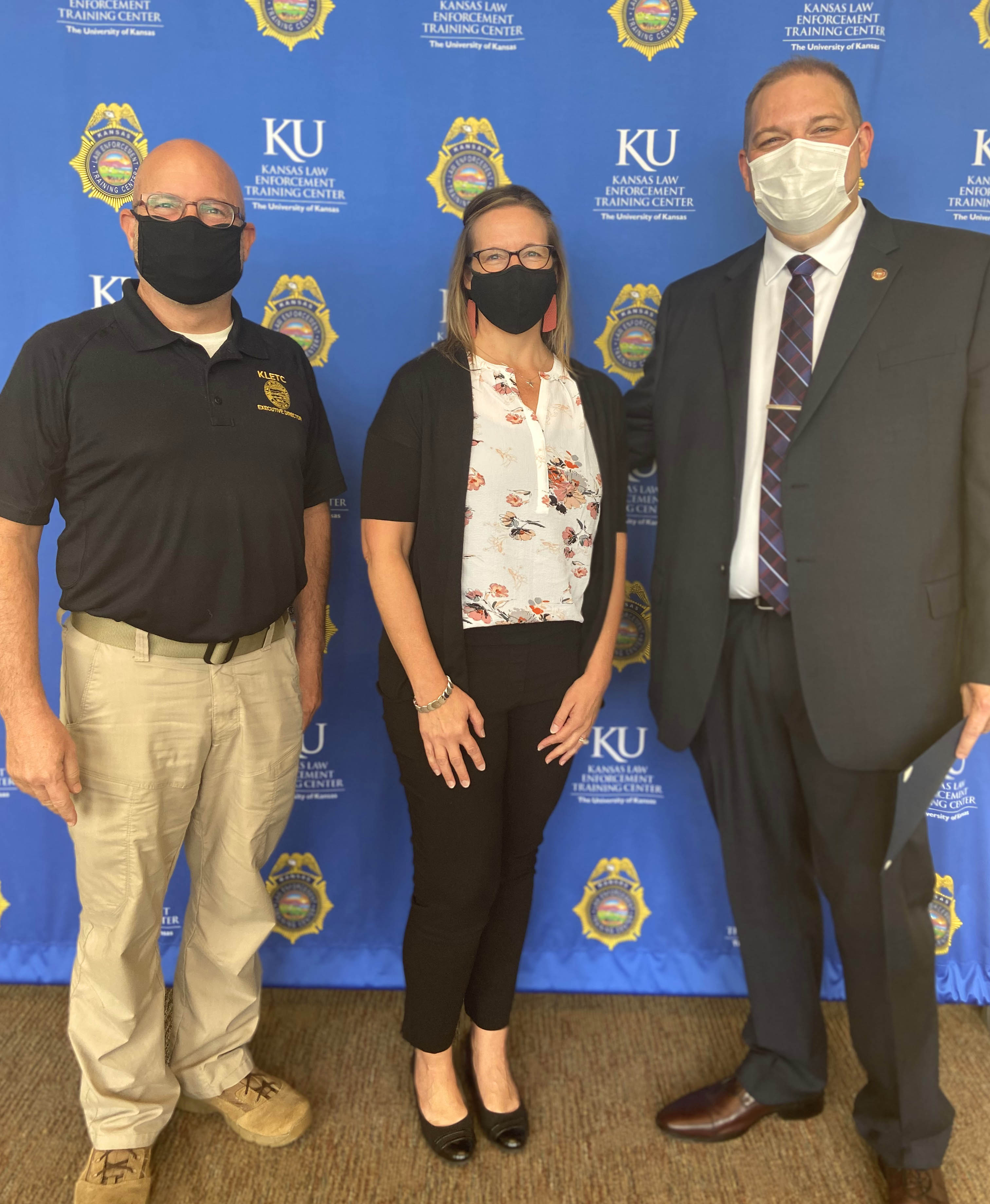 KLETC Executive Director Darin Beck stands with CACKS Executive Director Juliane Walker and 268 class president Christopher Engle-Tjaden