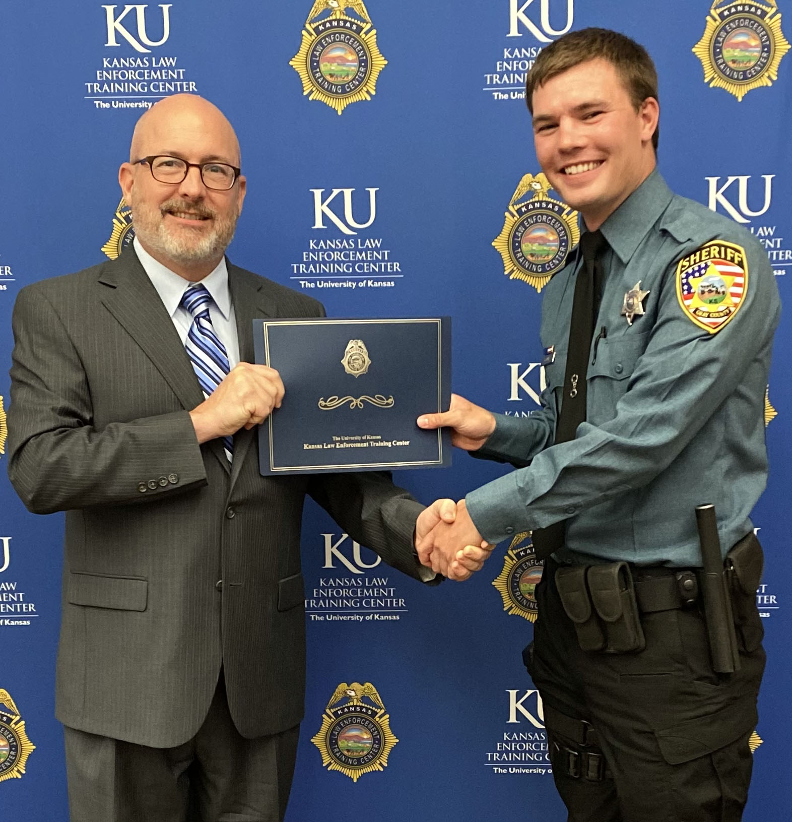 KLETC Executive Director Darin Beck and 281st Basic Training Class President Hayden Goudy.