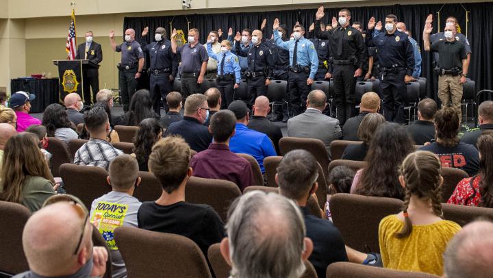 The 282nd Basic Training Class recites the Law Enforcement Oath of Office in front of the attending audience