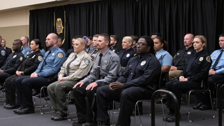 Captain Guy Schroeder of the Wichita University Police Department addresses the 294th graduating class