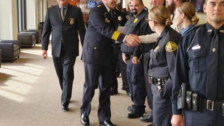Interim Chief Livingston shakes hands with 301 graduates
